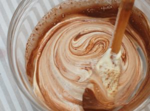 Ice cream, milk, Nove Glacier Mint, and other ingredients in a glass mixing bowl.  Frozen mint hot chocolate is a great cannabis recipe by Nove.