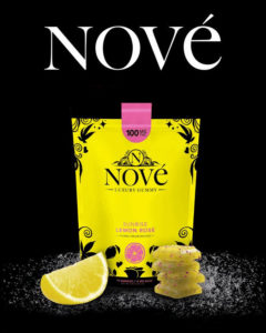 Nove Luxury Edibles' new Lemon Rose gummy on a black background, surrounded by a sprinkling of sugar.